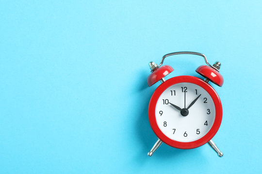 Retro alarm clock on color background, space for text