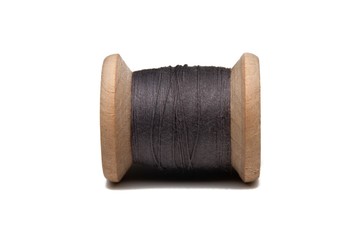 Wooden coil with thread on a white isolated background