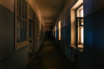 Dark creepy corridor of abandoned hospital at night. Horror concept