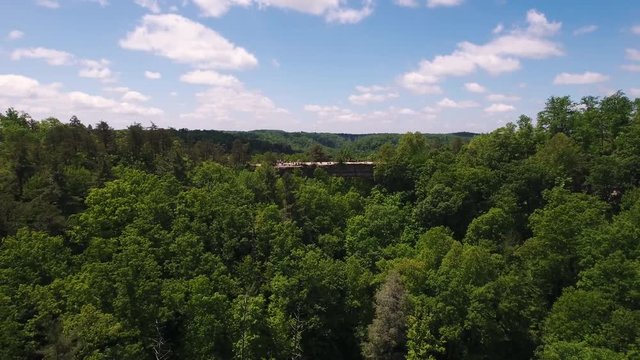 Aerial, natural bridge in woods of Kentucky