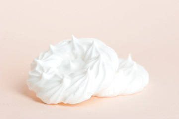 Meringues on a light background. Close-up. Macro shooting.
