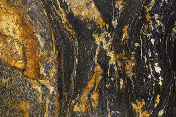 Closeup black and brown granite with natural pattern texture background.