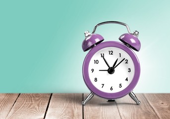 Retro alarm clock on table  background
