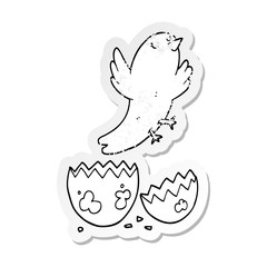 distressed sticker of a cartoon bird hatching from egg