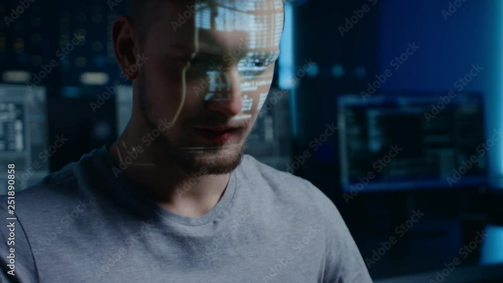 Poster Portrait of Software Developer / Hacker Working on Personal Computer, Projected Moving Code Numbers and Characters Reflect on His Face. Dark Room Full of Electronics. Hacking and Programming Concept