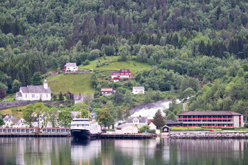 View of Hellesylt, Norway. Hellesylt lies at the head of the Sunnylvsfjorden, which is a branch of the Storfjorden, and which the more famous Geirangerfjorden in turn branches off nearby.