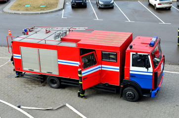 Special rescue fire truck, top view. Protection, rescue from danger. Fire fighter in protective helmet.