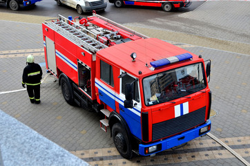 Fototapeta na wymiar Special rescue fire truck, top view. Protection, rescue from danger. Fire fighter in protective helmet.