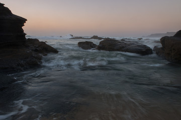 Fototapeta na wymiar The power of ocean waves and portuguese rocky coast from Lagos, Algarve
