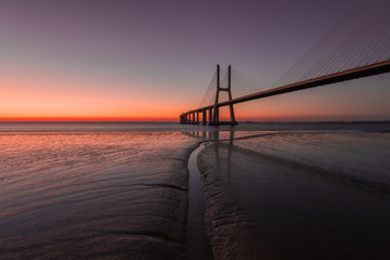 Fototapeta na wymiar Peaceful atmosphere at Vasco de Gama Bridge in Lisbon during sunrise. Ponte Vasco de Gama, Lisboa, Portugal