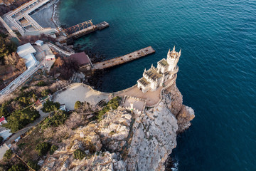 Swallow Nest aerial drone shot, ancient castle on top of mountain cliff near sea Yalta region, Crimea. Beautiful famous palace architecture and amazing nature landscape