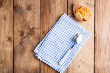 Croutons on a wooden background and free space for a plate. Top view. Copy space.