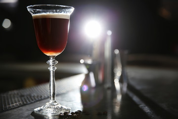 Glass of martini espresso cocktail on bar counter. Space for text
