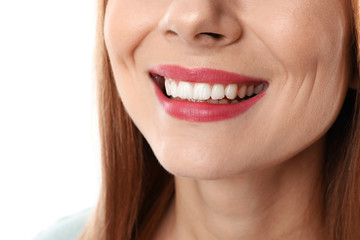 Smiling woman with perfect teeth on white background, closeup