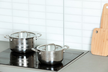 Clean pans on stove in kitchen. Space for text