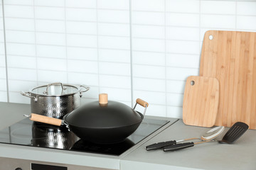 Set of clean cookware and utensils on table in kitchen