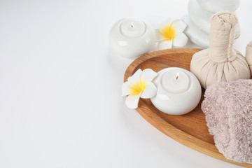 Beautiful spa composition with candles and flowers on white background