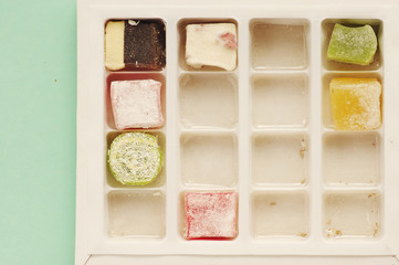 Traditional turkish delight  on blue background.  Arabic traditional dessert rahat lukum in a box. 