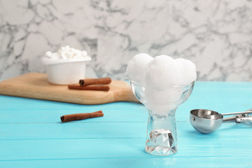 Bowl of tasty snow ice cream balls on table against marble background. Space for text