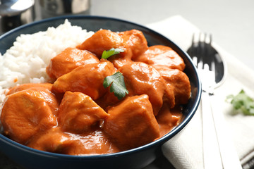 Delicious butter chicken with rice served on table