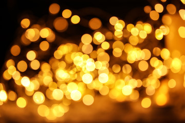 Gold glitter with bokeh effect on dark background