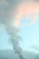 Colorful sky with clouds and steam pipe jet