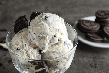 Bowl of chocolate cookies ice cream on table, closeup