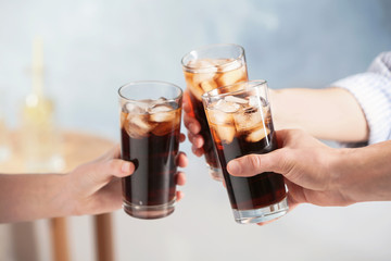 Friends with glasses of cold cola indoors, closeup