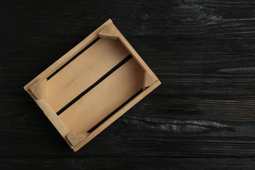 Empty wooden crate on dark background, top view with space for text
