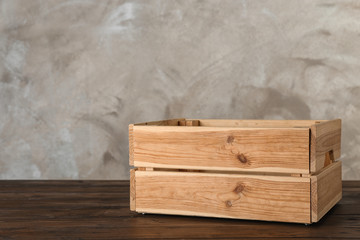Wooden crate on table against color background. Space for text