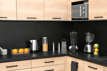 Obraz na płótnie Canvas Stylish kitchen counter with houseware, appliances and products