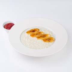 A plate of oatmeal porridge with fried banana. Hot and healthy breakfast every day, diet food.