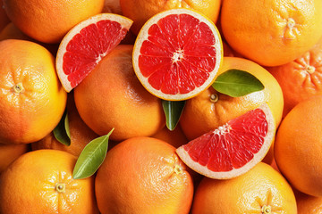 Many fresh ripe grapefruits as background, top view