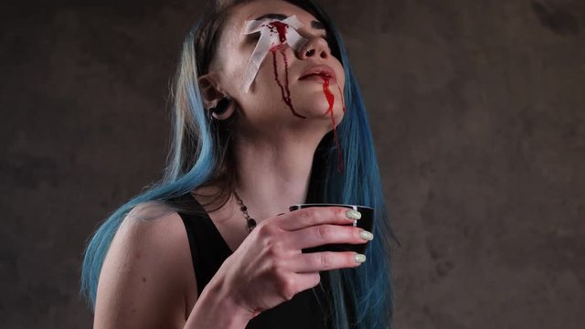 One eyed girl drinking blood