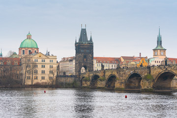 Prague, Czech republic. Famous historical Charles bridge with old town tower that crosses the Vltava river in old town. Czech legend has it that construction began on 9 July 1357 