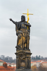 Prague, Czech Republic. Statue of St. John the Baptist, one of the ancient statues on the north side of the Charles Bridge, sculpted in 1857.