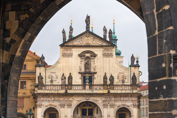 Prague, Czech Republic. Top of the Church of the Holy Saviour  seen trough the arch of Old Town Bridge Tower on Charles bridge.