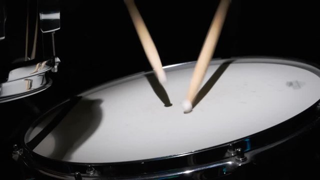 drumsticks drumming on a drum set closeup.