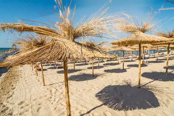 Straw umbrella on empty seaside beach, Bulgaria
