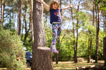 Little girl playing in the forest