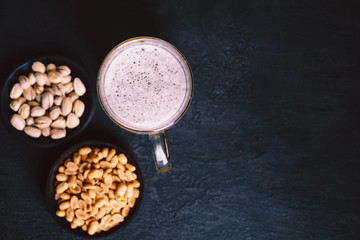 beer and snacks. bar table. restaurant, pub, oktoberfest food. mug of delicious lager drink and salted nuts. friday party atmosphere, craft brewery concept