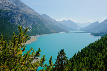 Naklejka na ściany i meble Beautiful green lake in Italian Alps Livigno surrounded by mountains