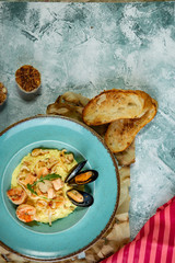 photo of delicious risotto with saffron and seafood on table.