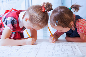 Team of design engineers collectively work on the project. Humorous photo of two cute child girls...