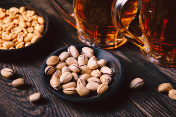 beer and snacks. bar table. restaurant, pub, oktoberfest food. delicious lager drink and salted nuts. friday party atmosphere, craft brewery concept