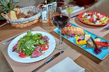 catering table set service with silverware and glass stemware at restaurant before party