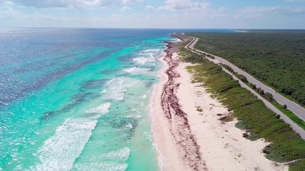 Aerial descending shot of tropical beaches in Cozumel, Mexico.