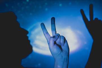 Man's hand making the symbol of victory and peace