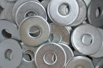 Metal fasteners. Many washers for construction as an industrial style background, close-up.