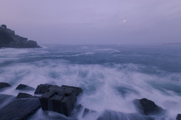 Seaport from Hondarribia at golden hour with fullmoon, at the Basque Country.